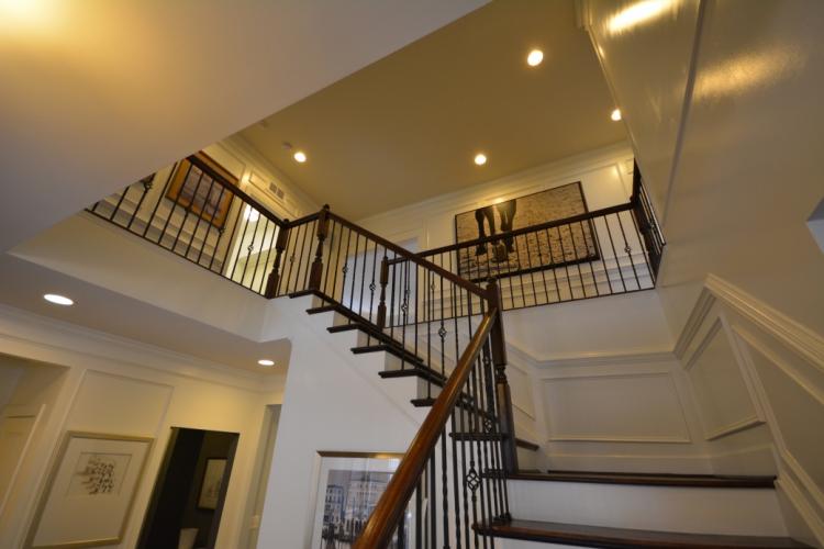 The stairs leading to the second floor from the front entry foyer.