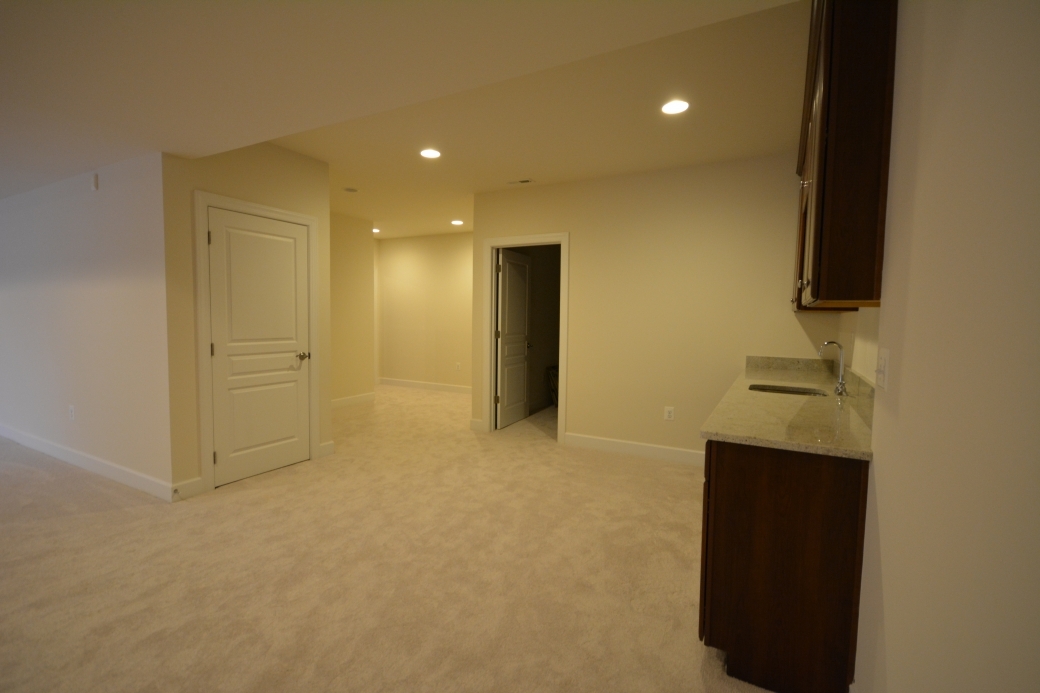 Reverse view of the basement entry and wet bar.