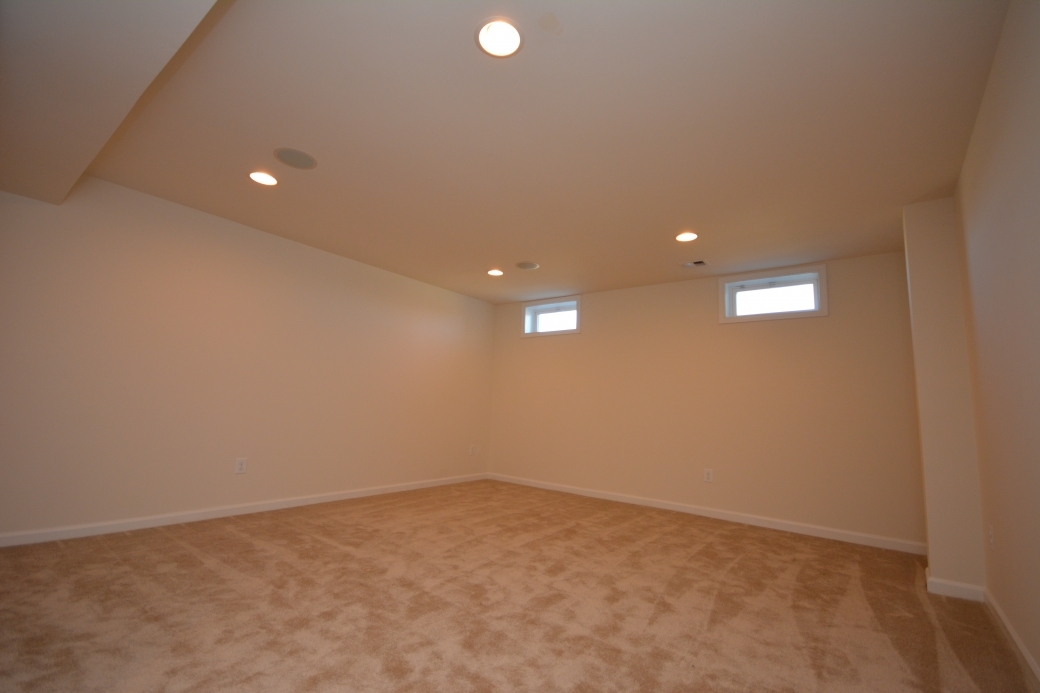 The basement media room (14'-11" by 16'-9").