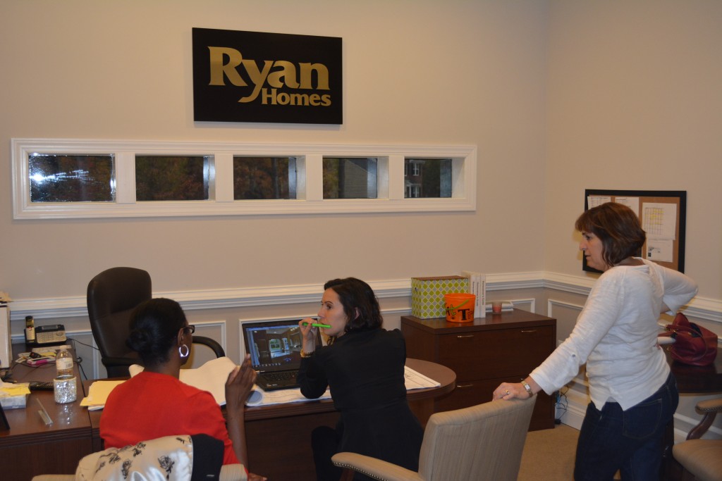 Maryanne Moyers, Long & Foster Realtors Associate Broker, and Lauren Keeler, Ryan Homes Sale Associate in Stafford County, work together while negotiating floor plans and contract prices for a client.