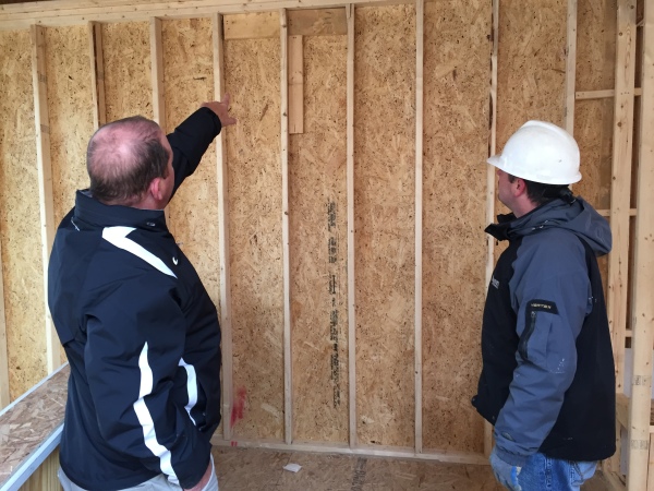 Our client points to damaged exterior sheathing to the Ryan Homes project manager at Liberty Knolls in Stafford County.