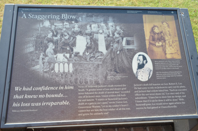 This National Park Service interpretive marker titled 'A Staggering Loss' is at the Jackson Shrine in Spotsylvania County. It shows a group of mourners surrounding the grave of Confederate Lieutenant General 'Stonewall' Jackson in Lexington, Virginia. The wife and daughter of 'Stonewall' Jackson are shown in the top right corner.
